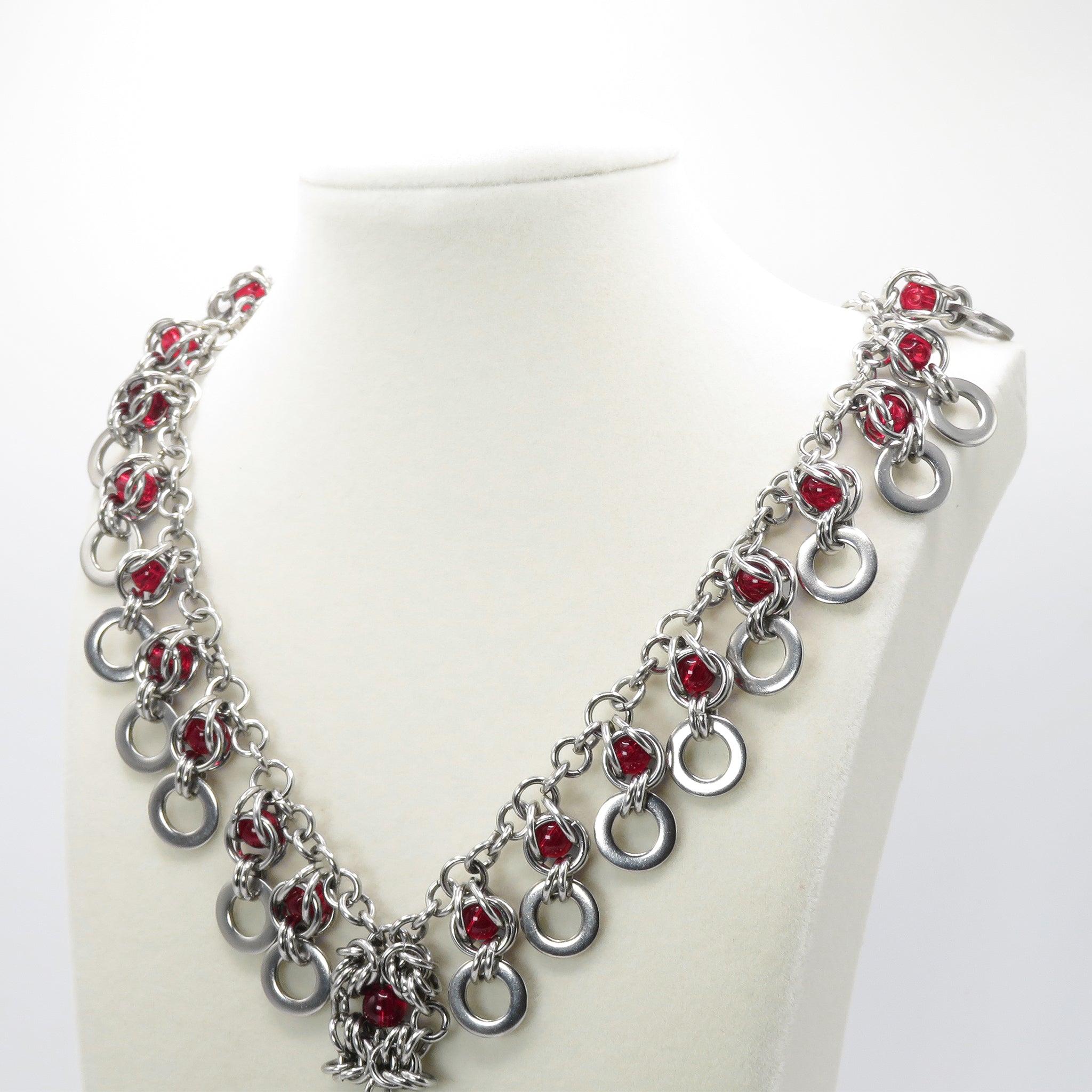 Close up of a Stainless Steel handmade chainmail necklace with red glass beads 