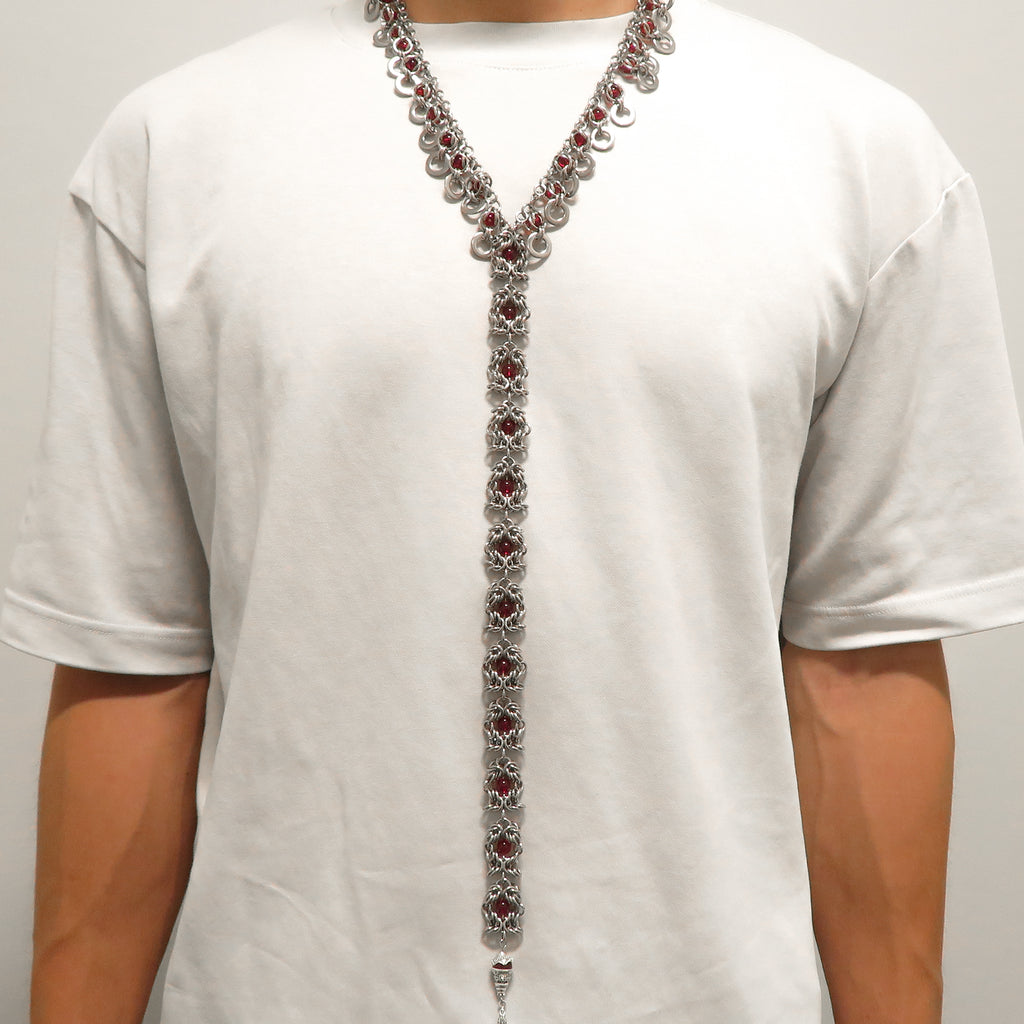 Long stainless steel handmade chainmail necklace with red glass beads on a model 