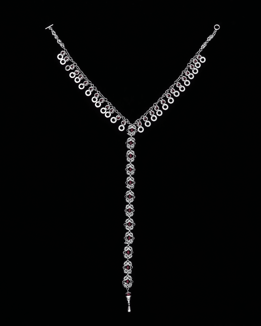 Stainless Steel handmade chainmail necklace with red glass beads on a black background